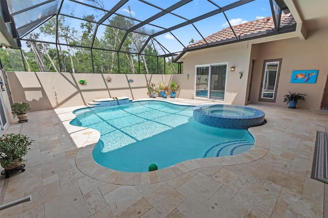 view of pool featuring an in ground hot tub, a patio, and glass enclosure