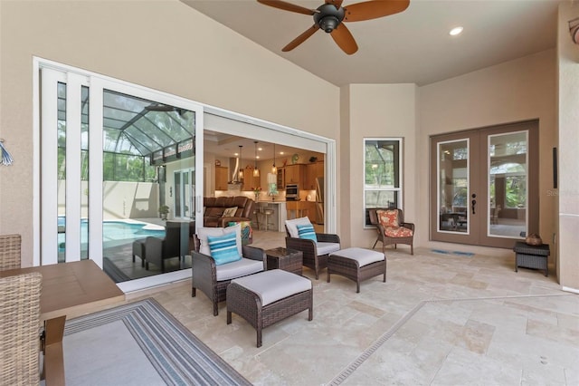 sunroom / solarium with french doors and ceiling fan