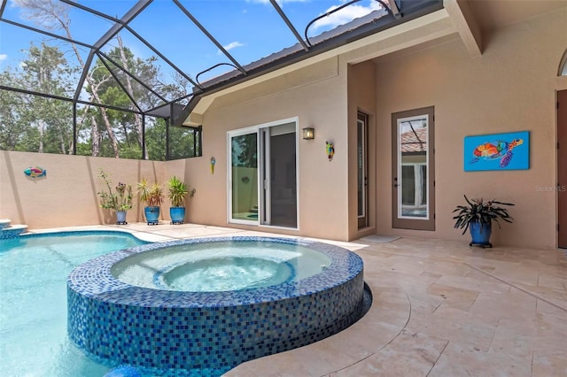 view of pool featuring a lanai, a patio area, and an in ground hot tub