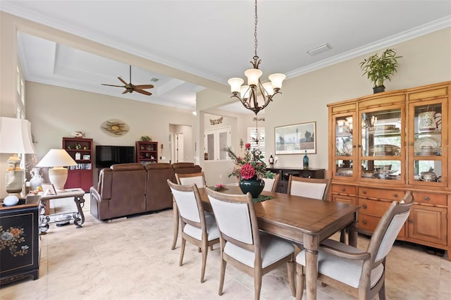 dining space with crown molding and ceiling fan with notable chandelier