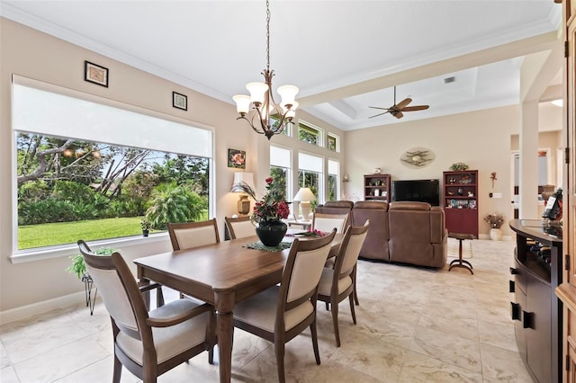 dining space with ornamental molding, ceiling fan with notable chandelier, and a tray ceiling