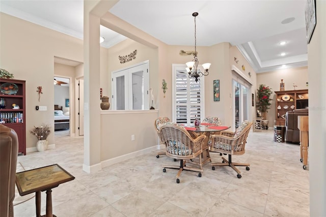 dining space with crown molding and a notable chandelier