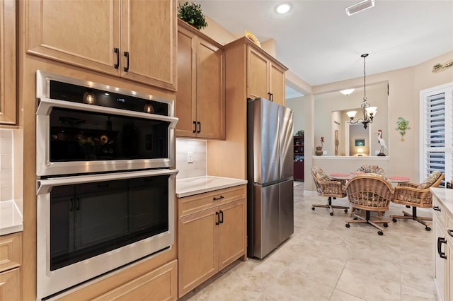 kitchen featuring a notable chandelier, decorative light fixtures, and appliances with stainless steel finishes