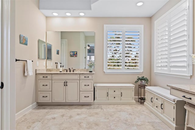 bathroom featuring ceiling fan and vanity