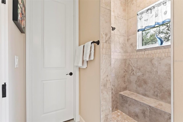 bathroom with a tile shower