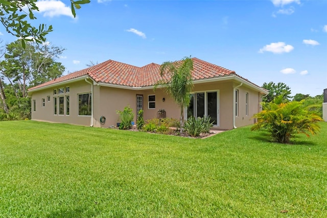 rear view of house with a yard