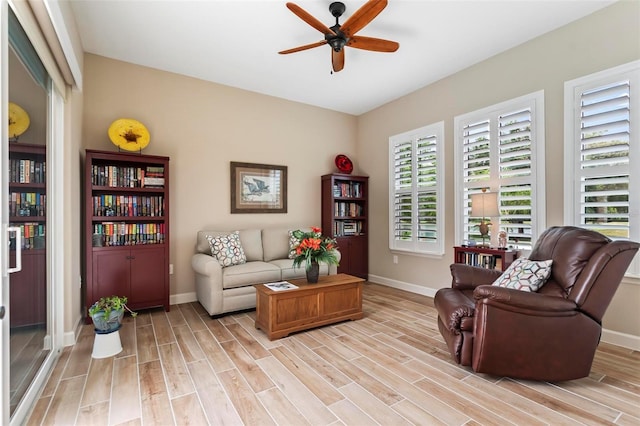 living area with ceiling fan and light wood-type flooring