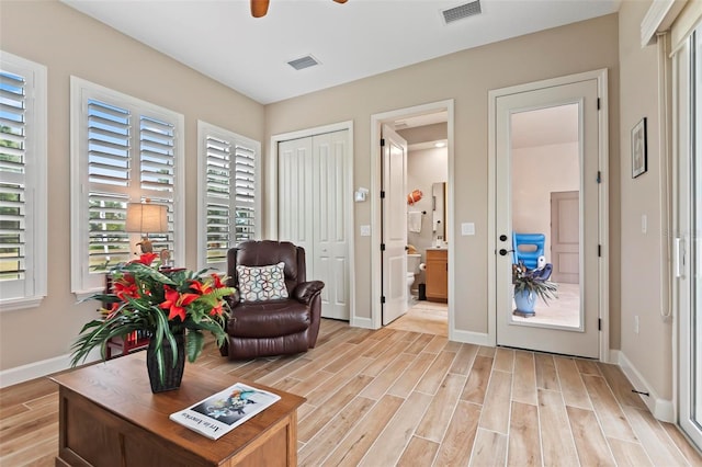 living area featuring ceiling fan and light hardwood / wood-style floors