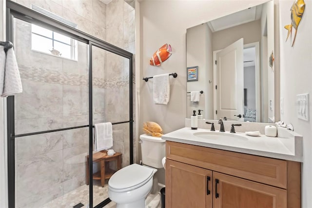 bathroom featuring an enclosed shower, vanity, and toilet