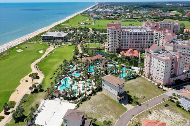 birds eye view of property featuring a beach view and a water view