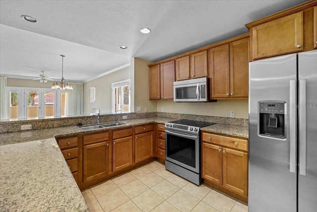 kitchen with light tile patterned floors, stainless steel appliances, sink, ceiling fan, and ornamental molding