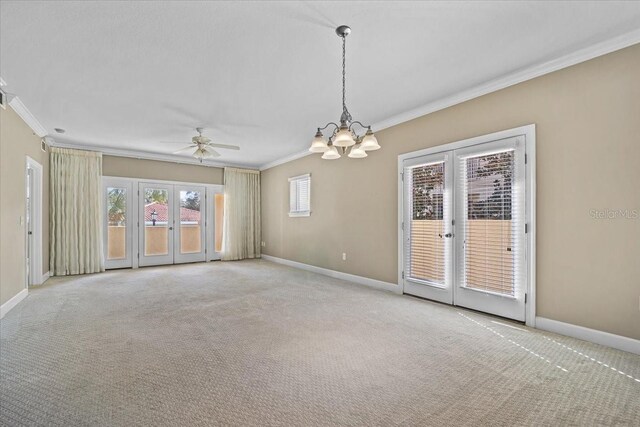 empty room with light carpet, baseboards, crown molding, and french doors