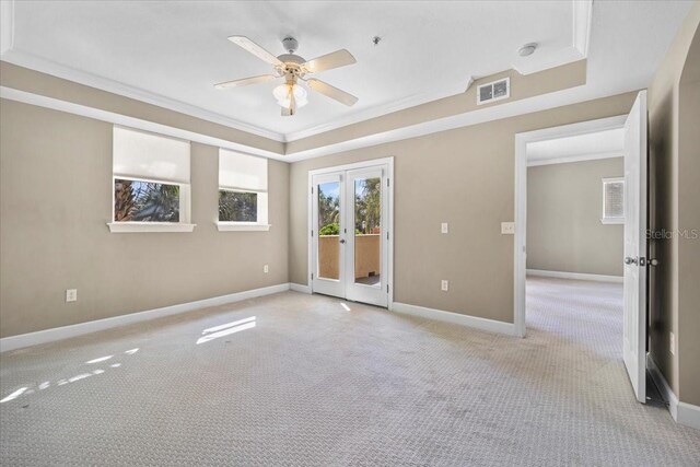 unfurnished room featuring french doors, crown molding, visible vents, light carpet, and baseboards