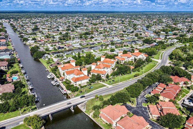 drone / aerial view with a water view and a residential view