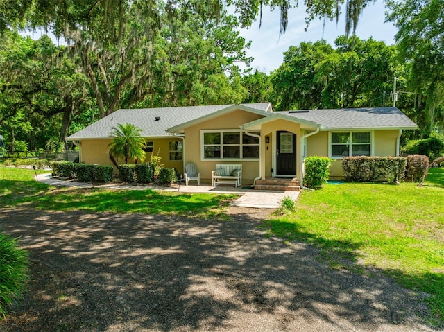 ranch-style home featuring a front yard