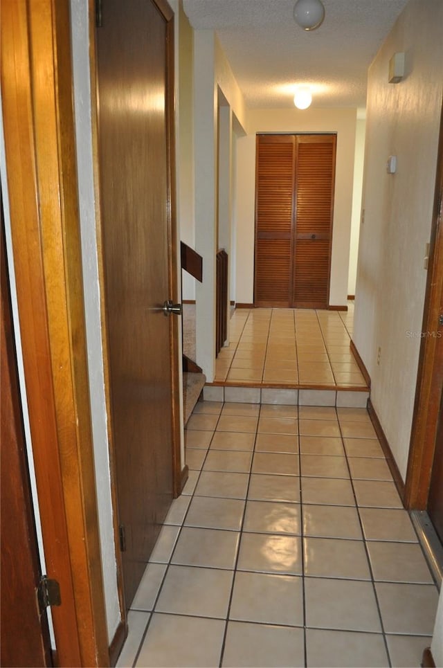 hallway featuring light tile floors