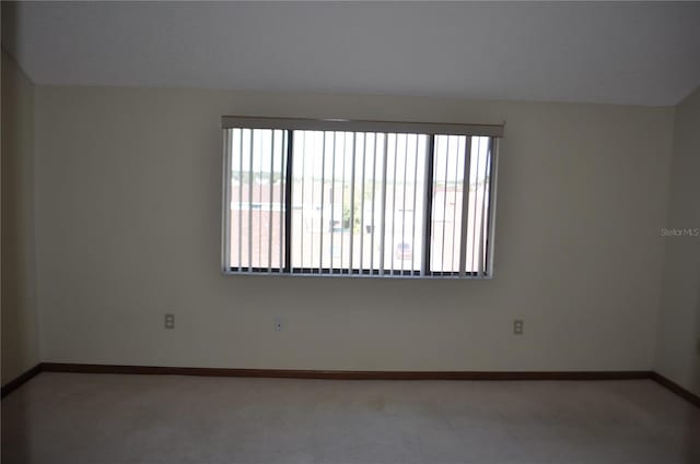 spare room with carpet and plenty of natural light