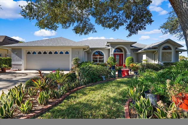 ranch-style house with a garage and a front lawn