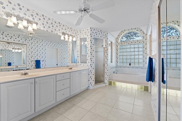 bathroom with tile patterned floors, vanity, a textured ceiling, and plus walk in shower