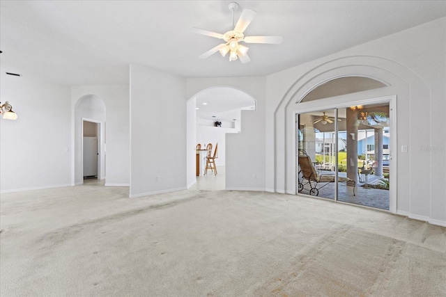 spare room featuring light carpet and ceiling fan