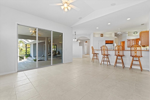 interior space with ceiling fan and vaulted ceiling