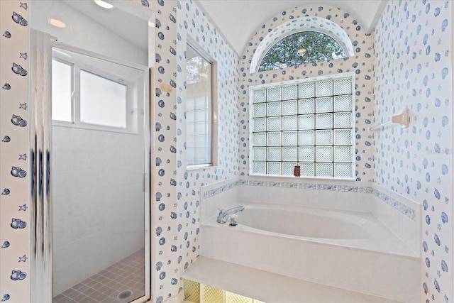 bathroom featuring plus walk in shower and vaulted ceiling