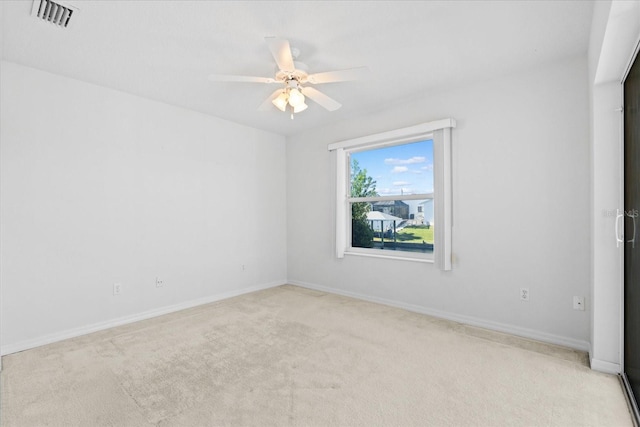 carpeted empty room featuring ceiling fan