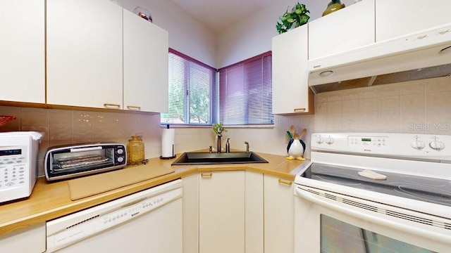 kitchen featuring sink, white cabinetry, white appliances, and tasteful backsplash