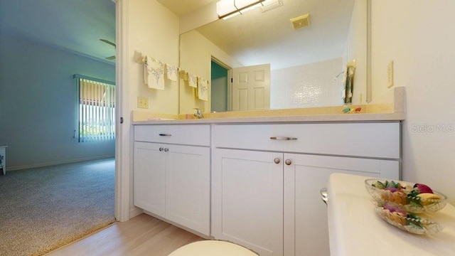 bathroom featuring oversized vanity and hardwood / wood-style floors