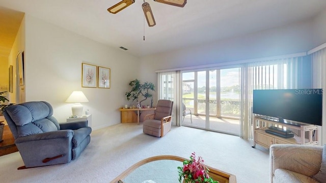 living room with ceiling fan and carpet floors