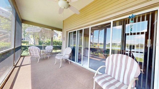 sunroom / solarium featuring plenty of natural light and ceiling fan