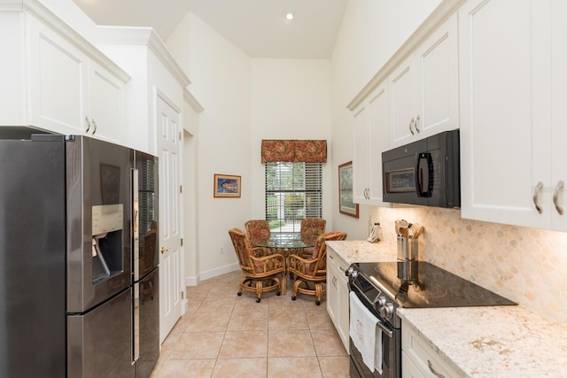 kitchen featuring stainless steel refrigerator with ice dispenser, light stone counters, backsplash, light tile floors, and range with electric stovetop