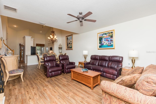 living room featuring high vaulted ceiling, wood-type flooring, a textured ceiling, and ceiling fan with notable chandelier