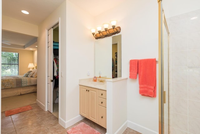 bathroom with a shower with shower door, tile flooring, and large vanity