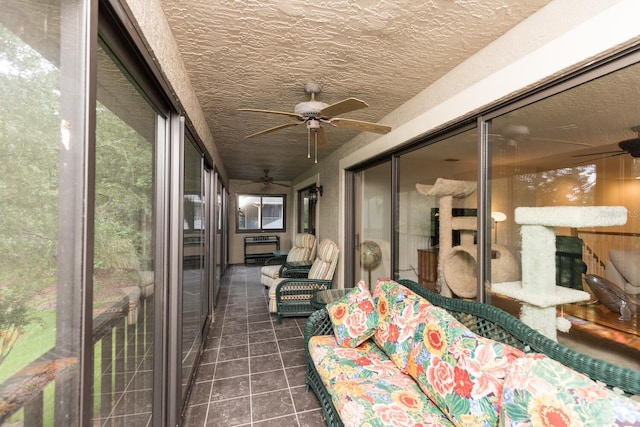 sunroom with ceiling fan
