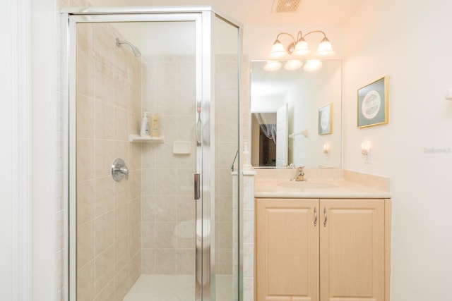 bathroom with a shower with door and large vanity