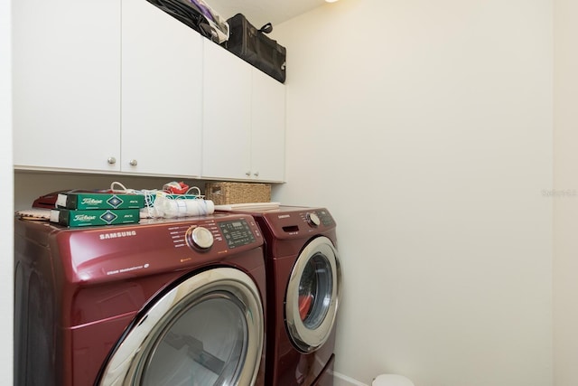 clothes washing area featuring cabinets and independent washer and dryer