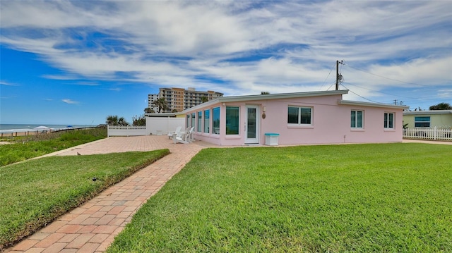 back of house featuring a patio and a yard