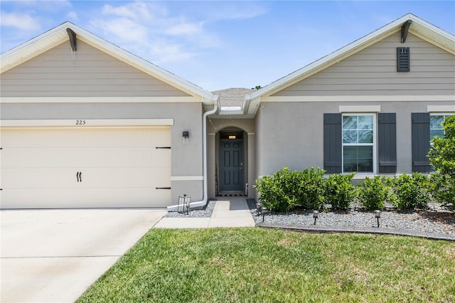 ranch-style home featuring a garage and a front lawn