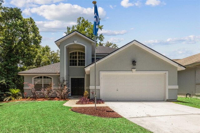 view of front of property featuring a garage and a front yard