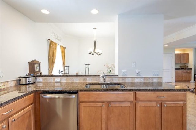 kitchen with dark stone countertops, a chandelier, hanging light fixtures, sink, and stainless steel dishwasher