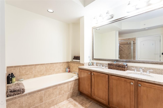 bathroom with tile patterned flooring, plus walk in shower, and vanity