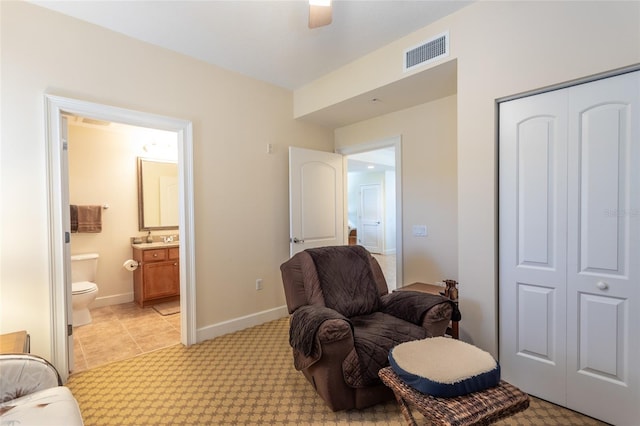 sitting room featuring ceiling fan and light colored carpet