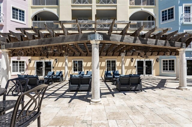 view of patio featuring an outdoor hangout area, ceiling fan, and a pergola