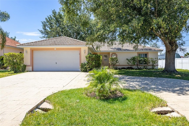 mediterranean / spanish house with a front yard and a garage