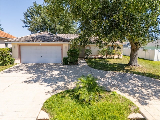 view of front of property with a garage and a front lawn