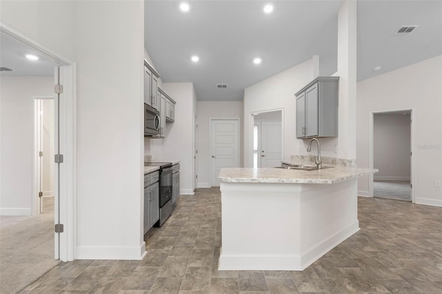 kitchen featuring gray cabinets, sink, kitchen peninsula, and range with electric stovetop