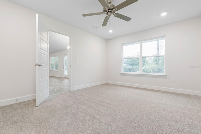 carpeted empty room featuring ceiling fan