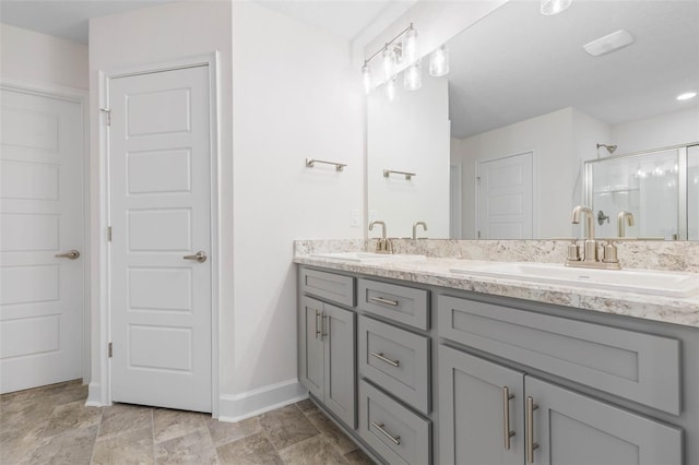 bathroom with a shower with door and vanity