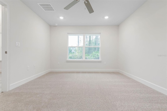 carpeted spare room with ceiling fan